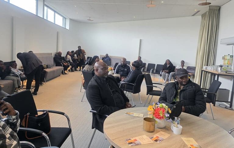 FJH members seated together during a community meeting